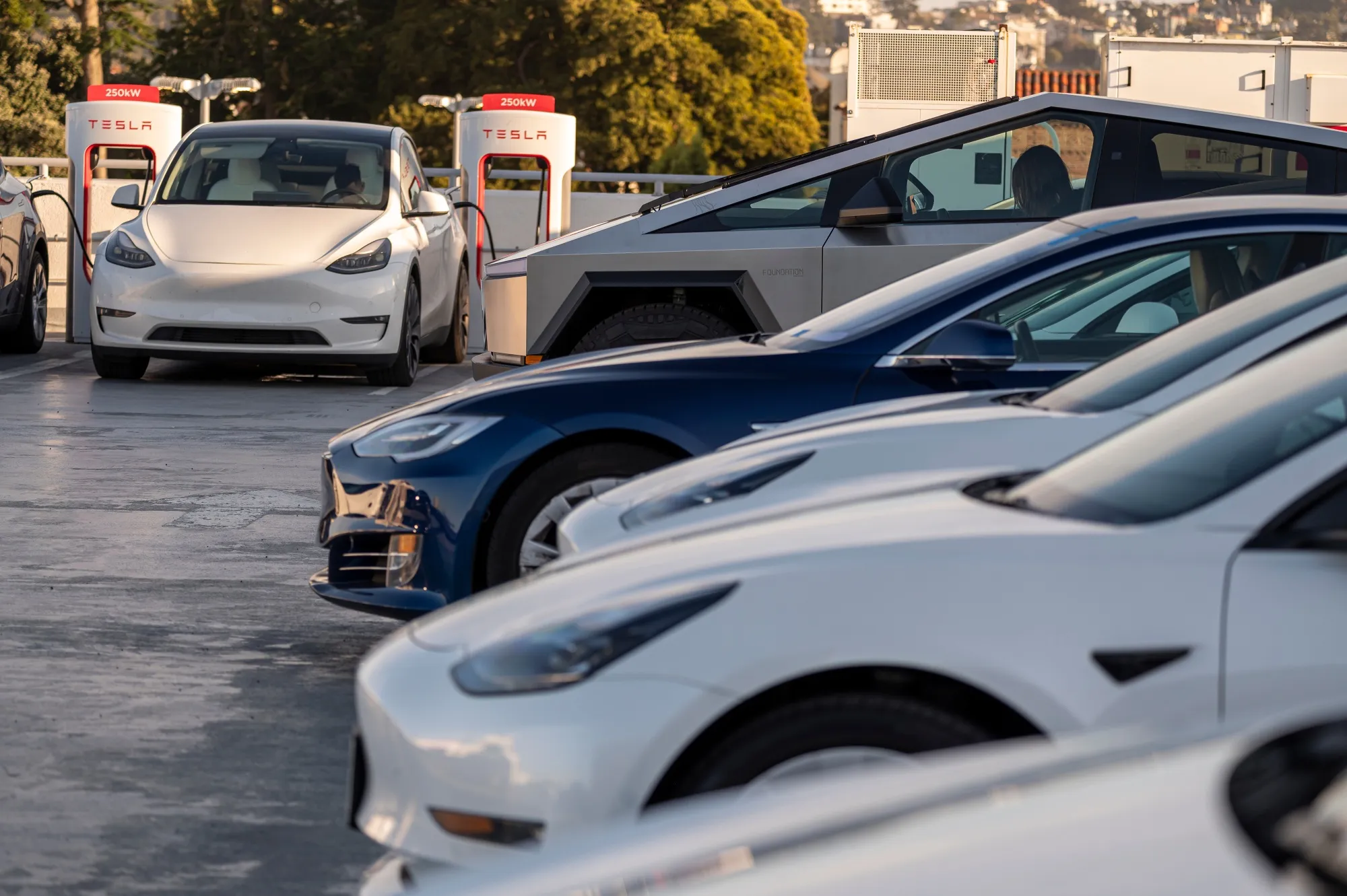 Tesla vehicles at supercharging stations in San Francisco.