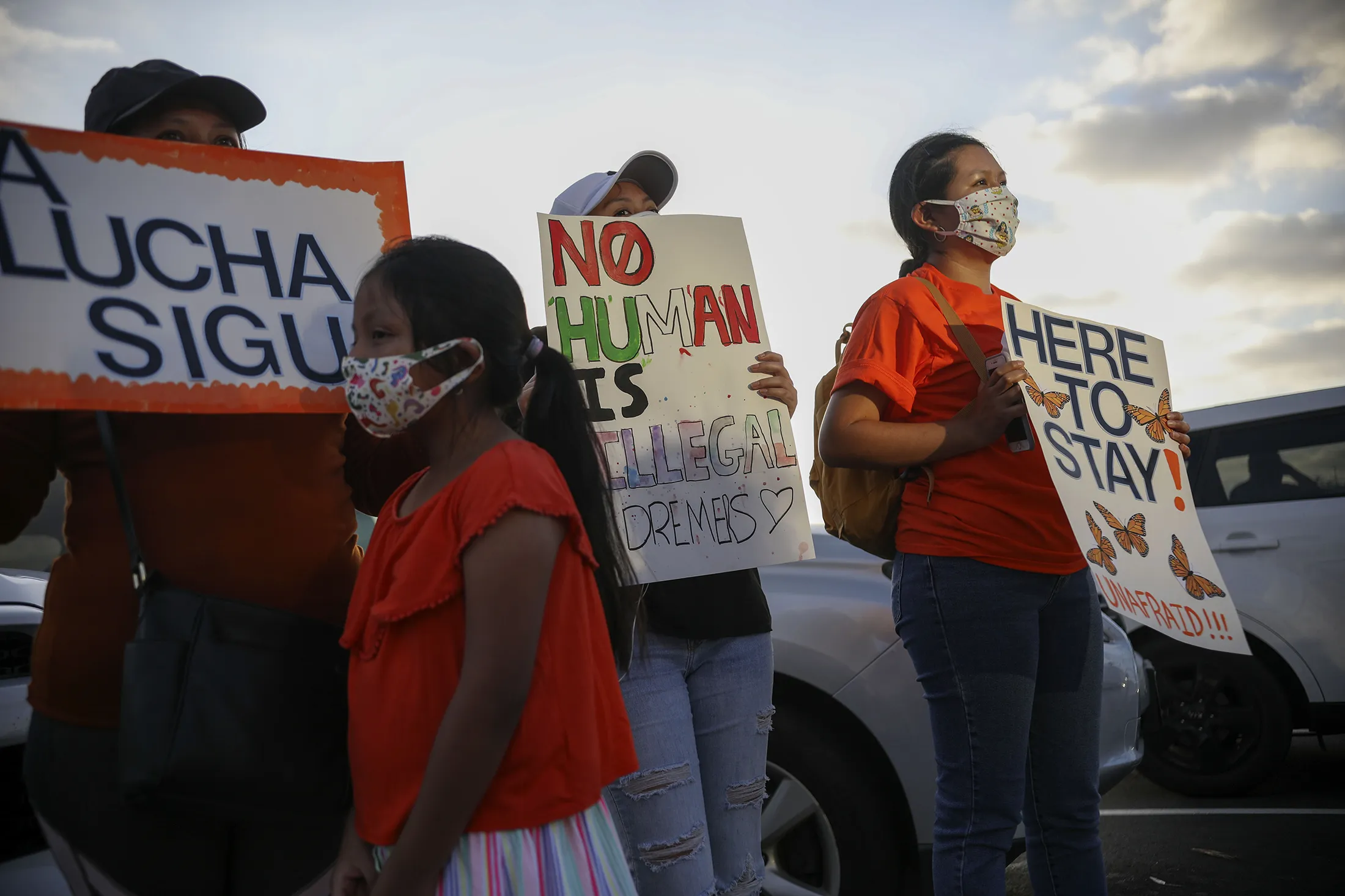 People hold signs during a rally in support of the Deferred Action for Childhood Arrivals (DACA) program, in San Diego, California.