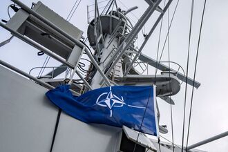The NATO flag is raised on a patrol ship near Sweden.