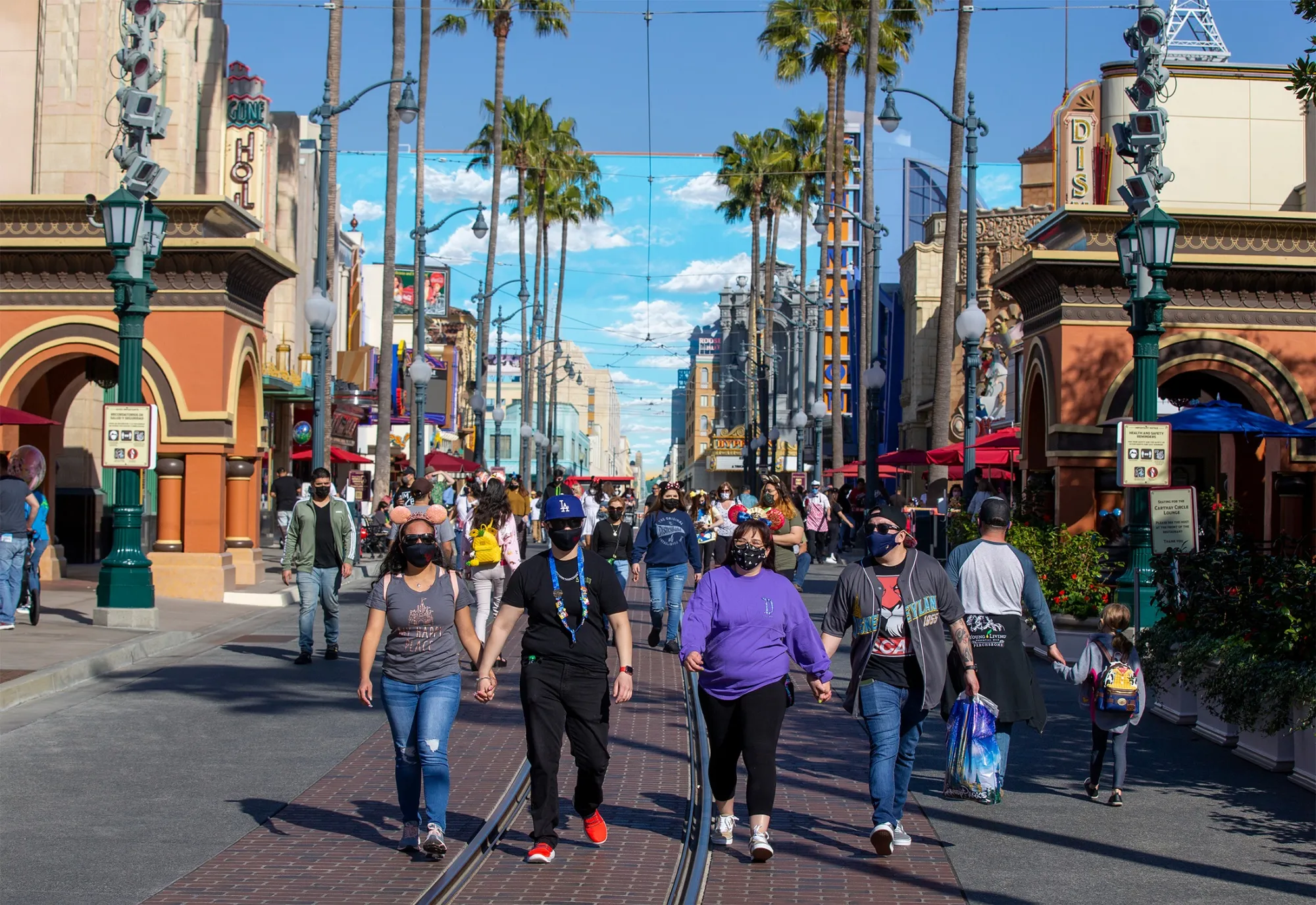 Visitors walk through Hollywood Land at Disney California Adventure Park in Anaheim, Calif., in March.
