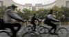 Cyclists ride past the People's Bank of China headquarters in Beijing.