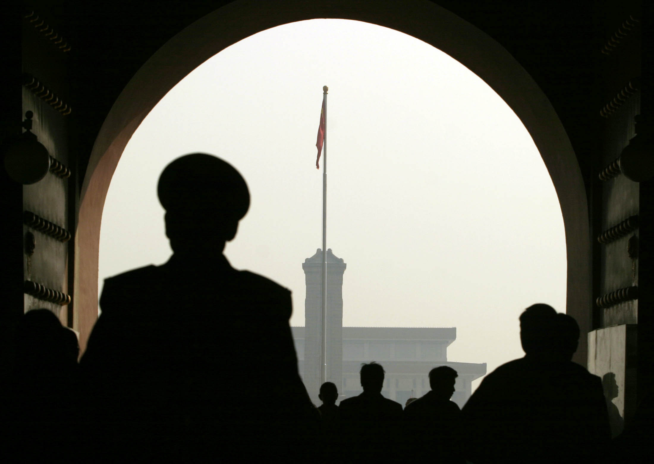 A Chinese policeman patrols Tiananmen Square as China's leaders arrive for the country's annual congress NPC, the National People's Congress, in Beijing 08 March 2004.
