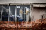 Health workers are seen inside the 'red zone' of an Ebola treatment centre,&nbsp;Democratic Republic of Congo.