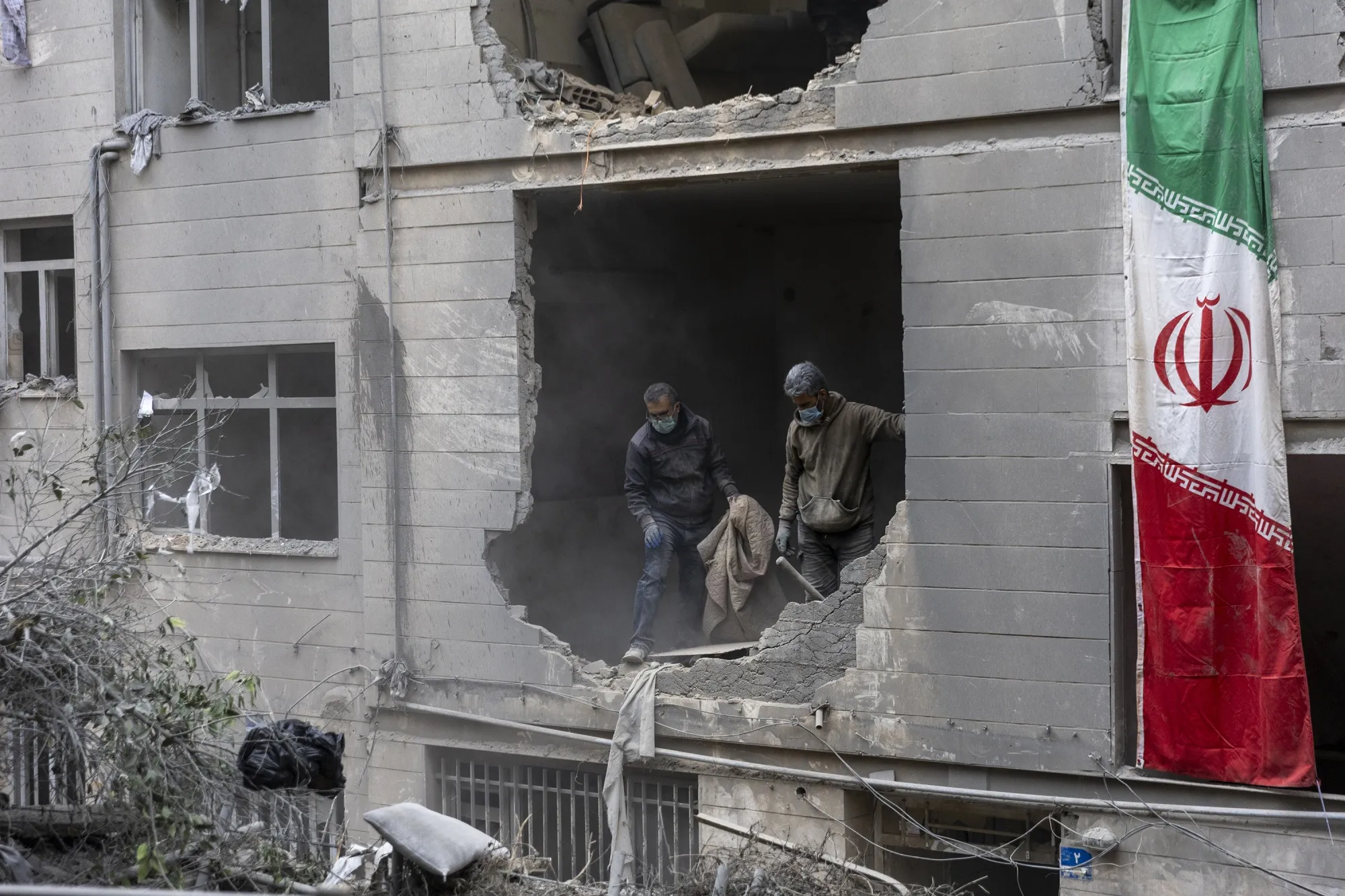 People clear rubble in a house in the Beryanak District of Tehran, after it was damaged by missile attacks two days before, on March 15.