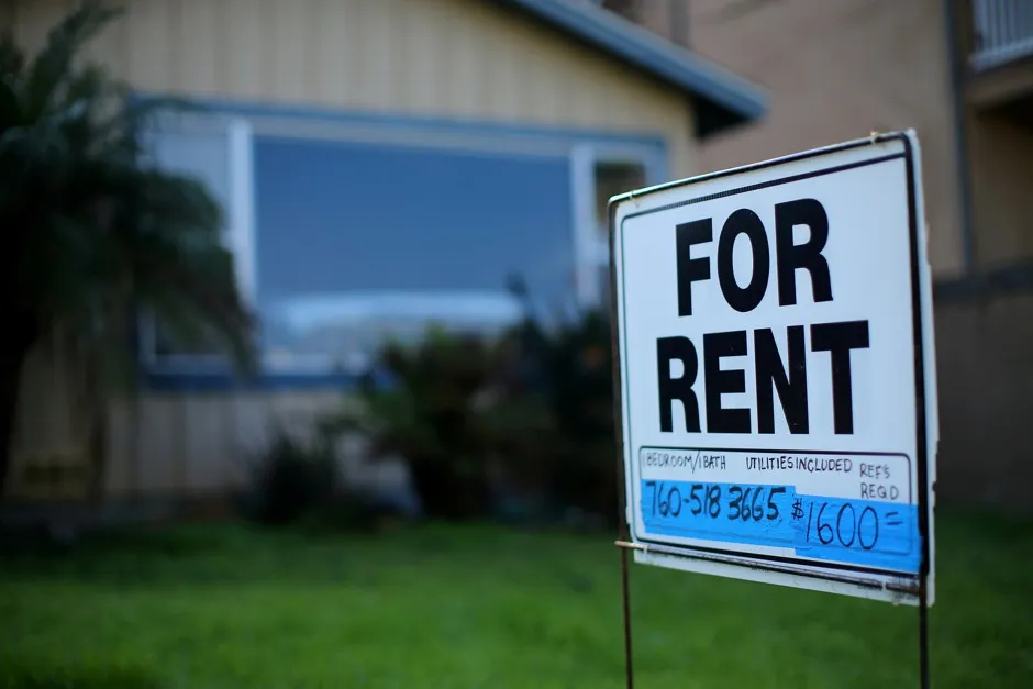 A "For Rent" sign is posted outside a residential home in Carlsbad, California.
