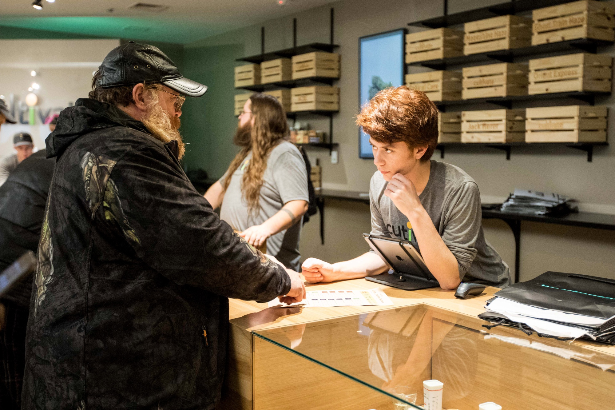 An employee helps a customer at a cannabis dispensary in Leicester, Massachusetts.