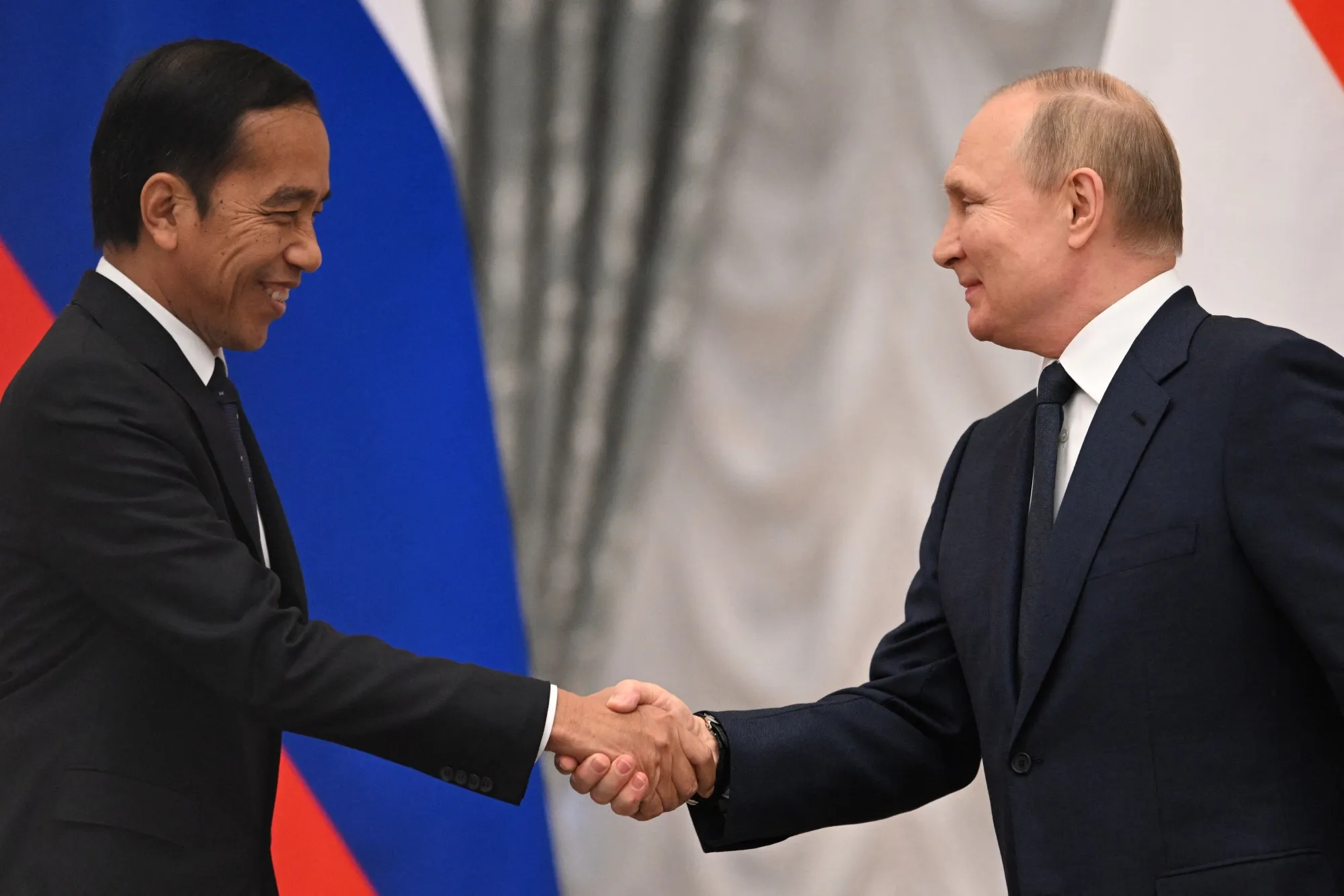 Vladimir Putin, right, shake hands with Joko Widodo&nbsp;in Moscow on June 30.