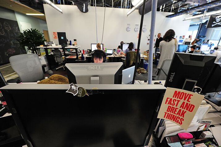 Employees work at their computers at the