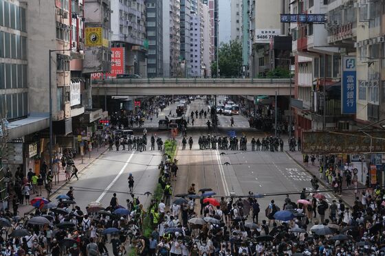 Hong Kong Files First Charges Under New Law, Bans Rallying Cry
