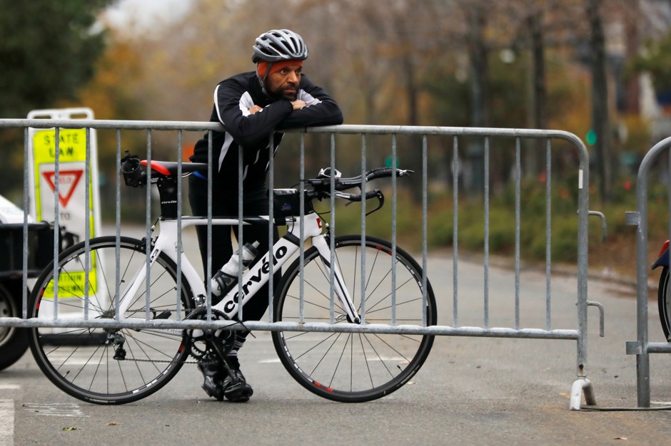 A cyclist stands at a police barricade outside the New York City bike path where a driver mowed down pedestrians and cyclists on Tuesday.