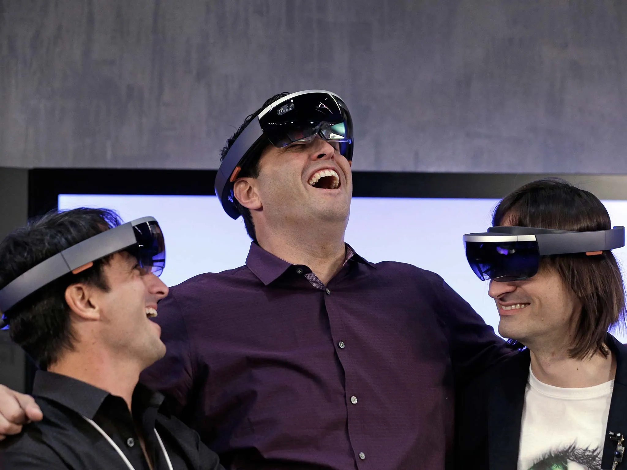 Microsoft's Joe Belfiore, left, Terry Myerson and Alex Kipman wear "Hololens" devices at an event demonstrating new features of the operating system Windows at the company's headquarters in Redmond, Wash. on Jan. 21, 2015.
