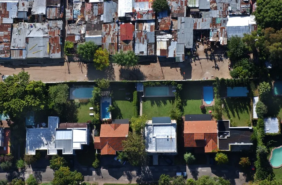 A wall divides a gated community from a shantytown in outer Buenos Aires.