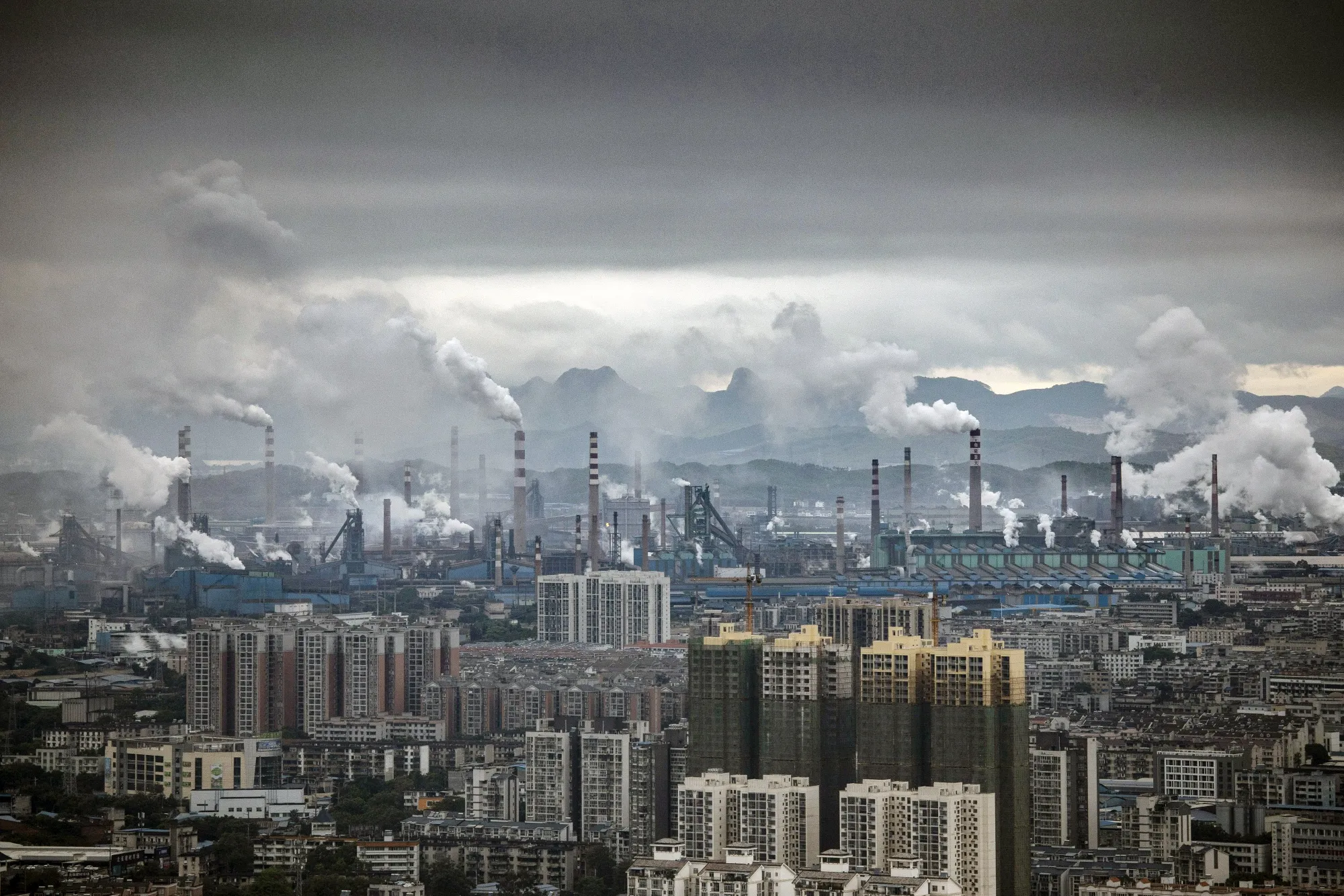Smoke and exhaust rise from a large industrial complex surrounding Liuzhou Iron &amp; Steel Co.'s facility in Liuzhou, China, on Monday, May 17, 2021.