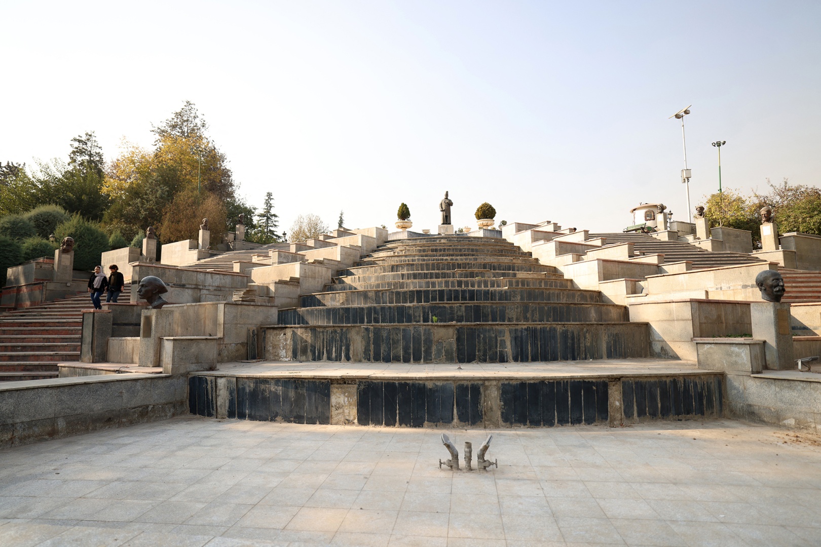A dry water feature collects dust in Mellat Park in Tehran on Nov. 9. Photographer: Atta Kenare/AFP/Getty Images