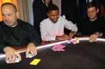 Tyrone Davis, center, at the final table of the Take ‘Em to School poker tournament.