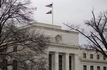 American flag flies outside the U.S. Federal Reserve building in Washington, D.C.