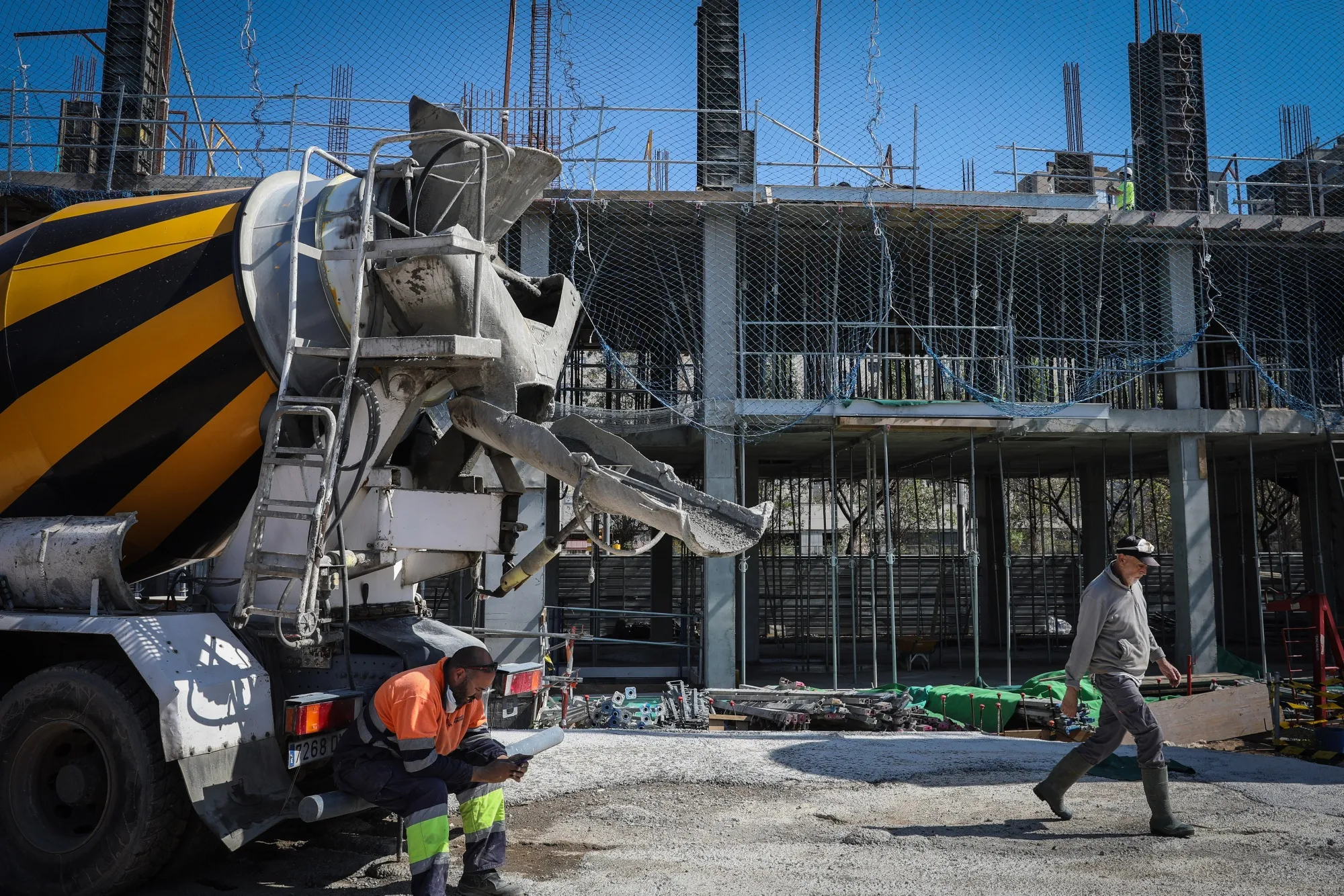 A cement mixer trucks stands at a construction site in Barcelona.