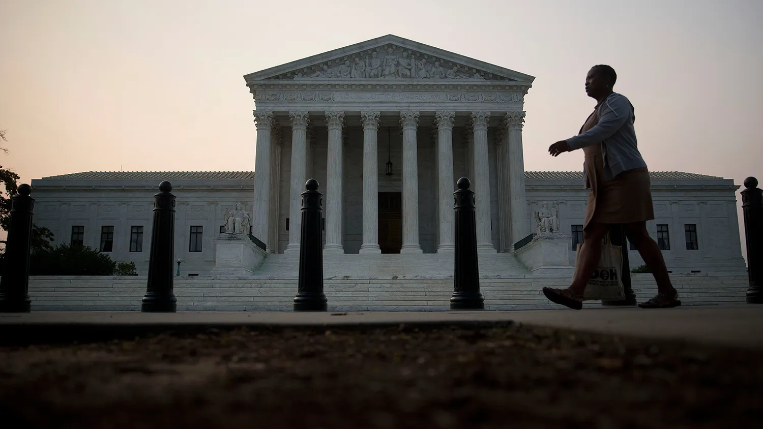 A pedestrian walks past the U.S. Supreme Court in Washington, D.C., U.S., on Wednesday, June 10, 2015.
