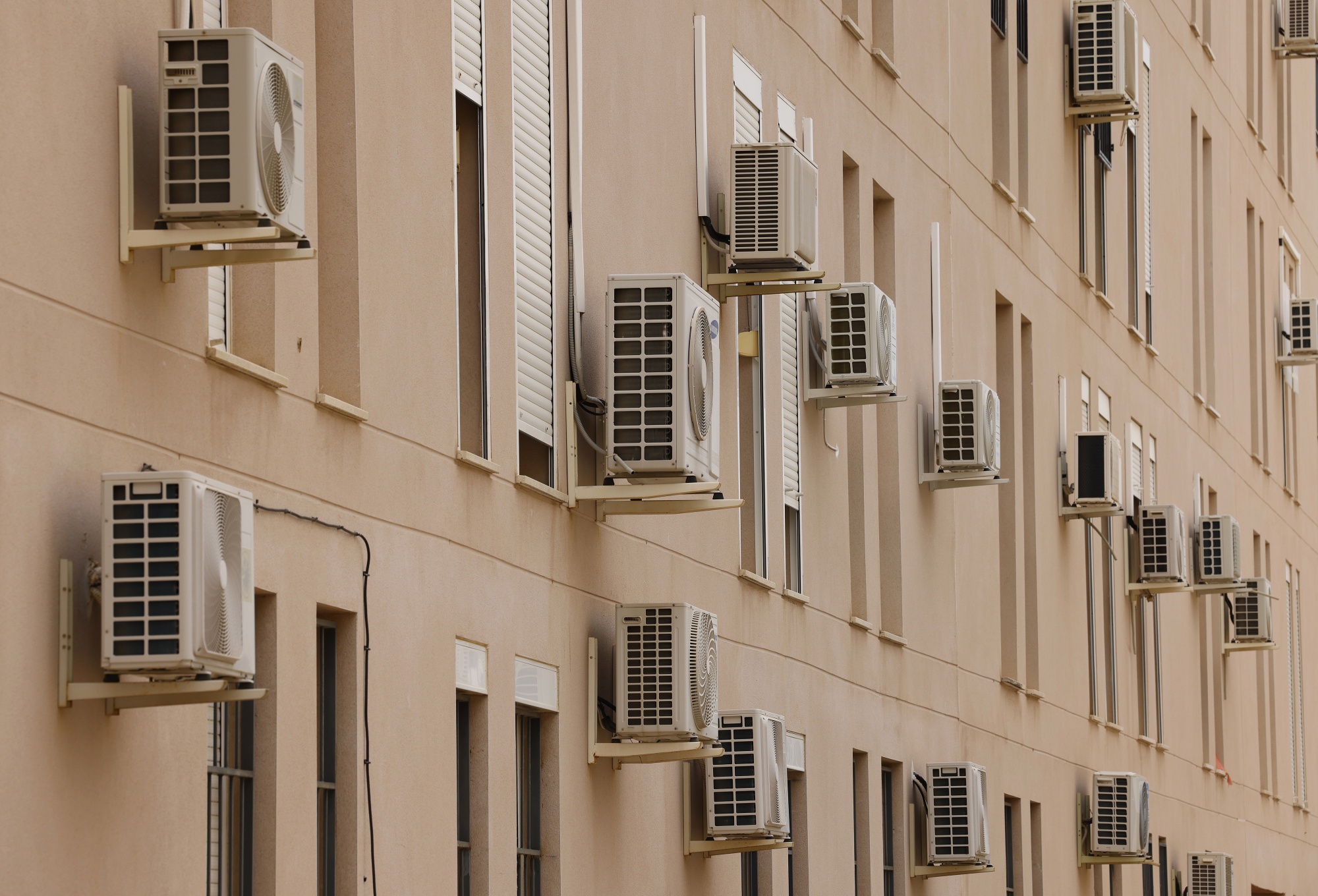 Air-conditioning units on the facade of a building during a heat wave in Seville, Spain, in June.