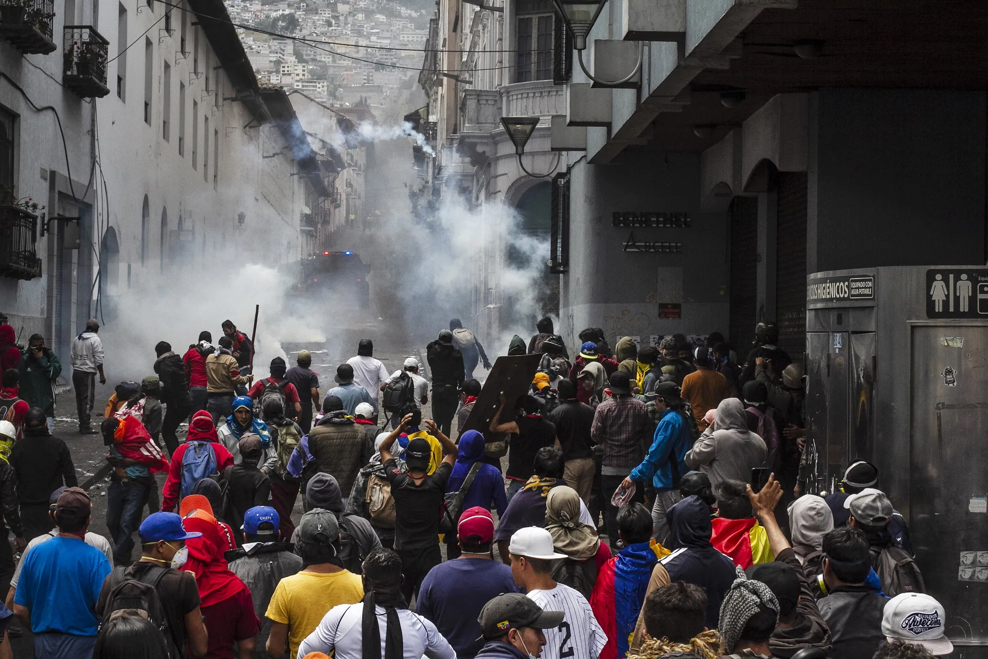 Riot police fire tear gas during a protest in the Historic Center neighborhood of Quito, Ecuador, on Wednesday, Oct. 9, 2019. As Ecuadorian protesters infuriated by rising fuel prices invaded government offices and oil fields, the president and his administration fled the capital, warning of a coup.
