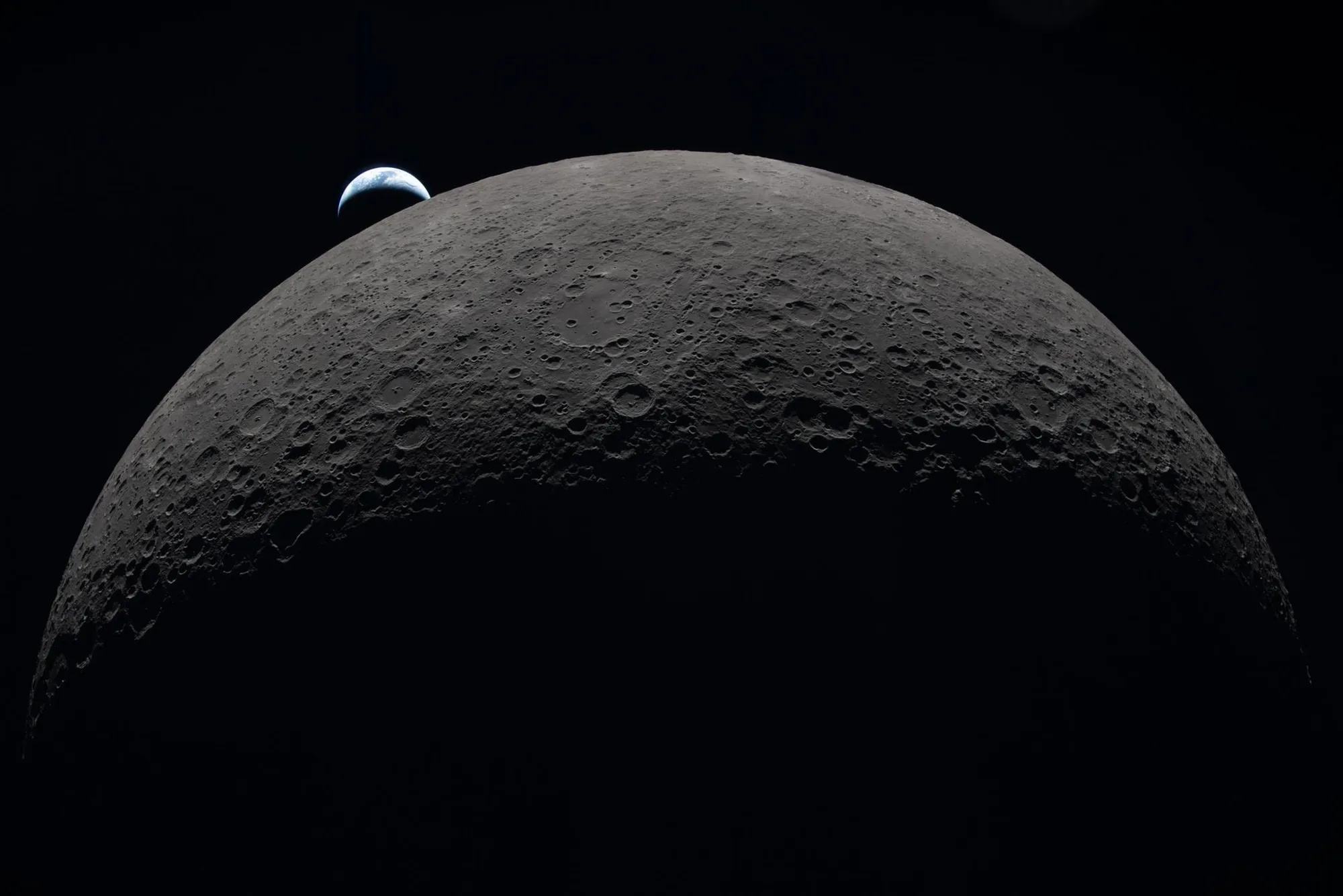Earth sets at 6:41 p.m. EDT, April 6,&nbsp;over the curved lunar surface,&nbsp;in this photo captured by the Artemis II crew during its&nbsp;journey around the far side of the moon.