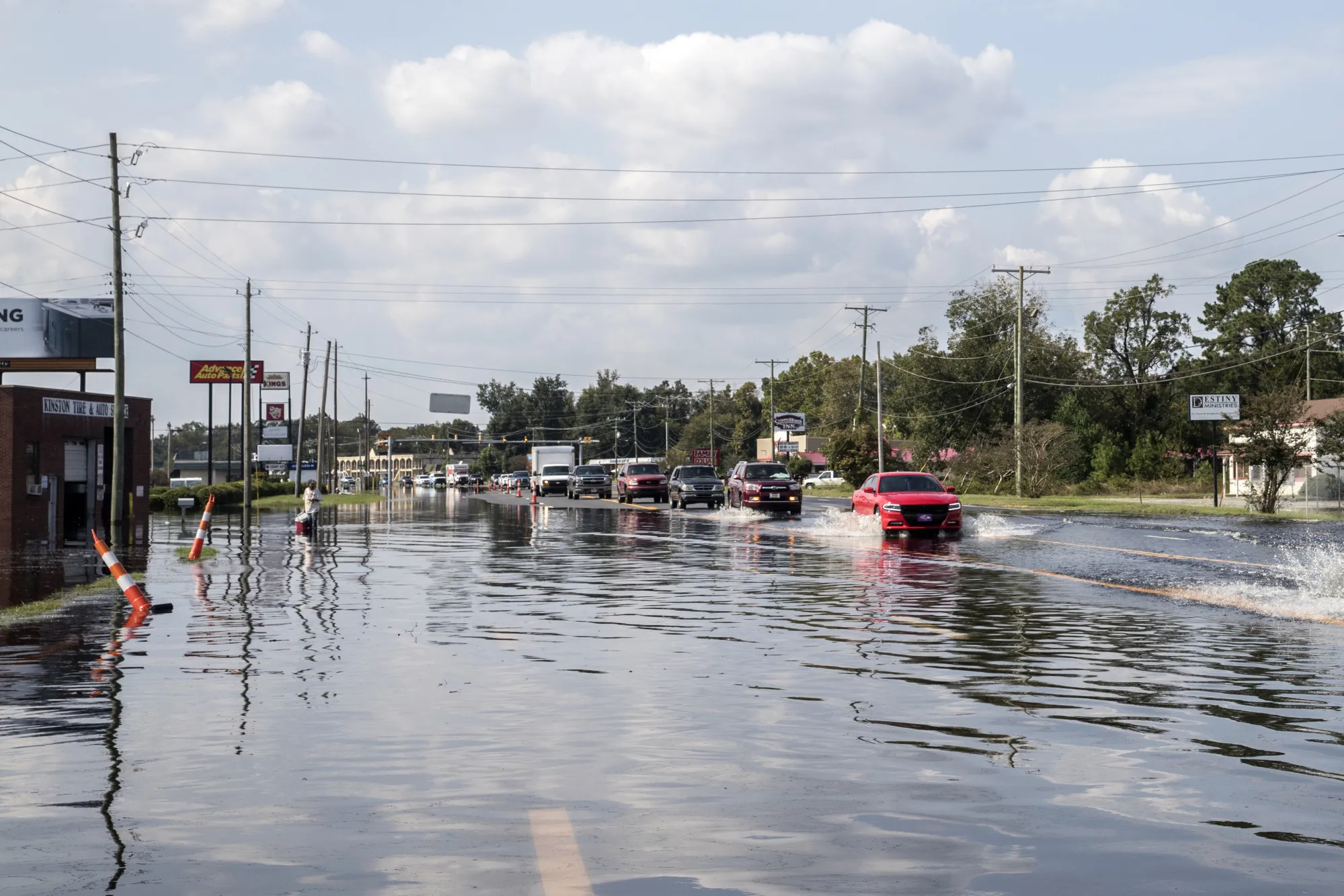 Vehicles drive along a flooded street after Hurricane Florence hit in Kinston, North Carolina, in 2018.&nbsp;