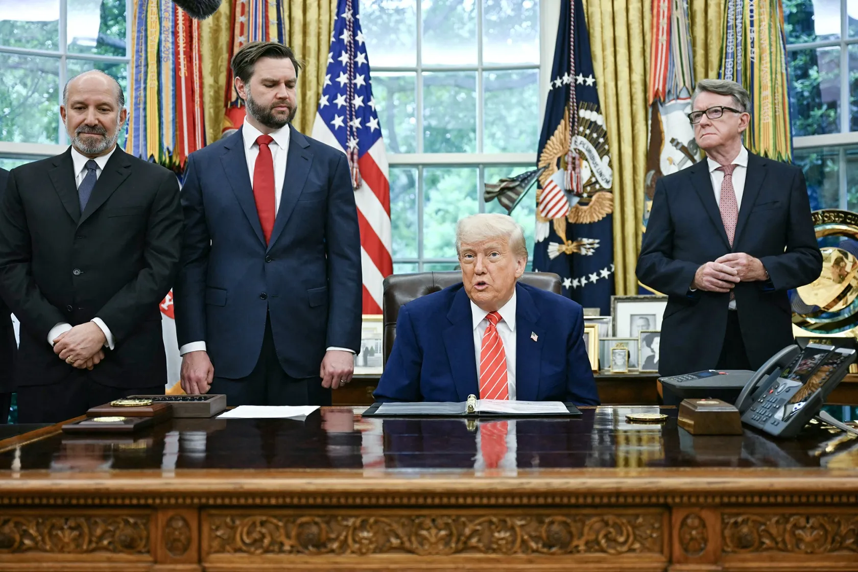 Donald Trump makes a trade announcement as Howard Lutnick, from left,&nbsp;JD Vance, and Peter Mandelson, British ambassador to the United States, look on in the Oval Office of the White House in Washington, DC, on May 8.