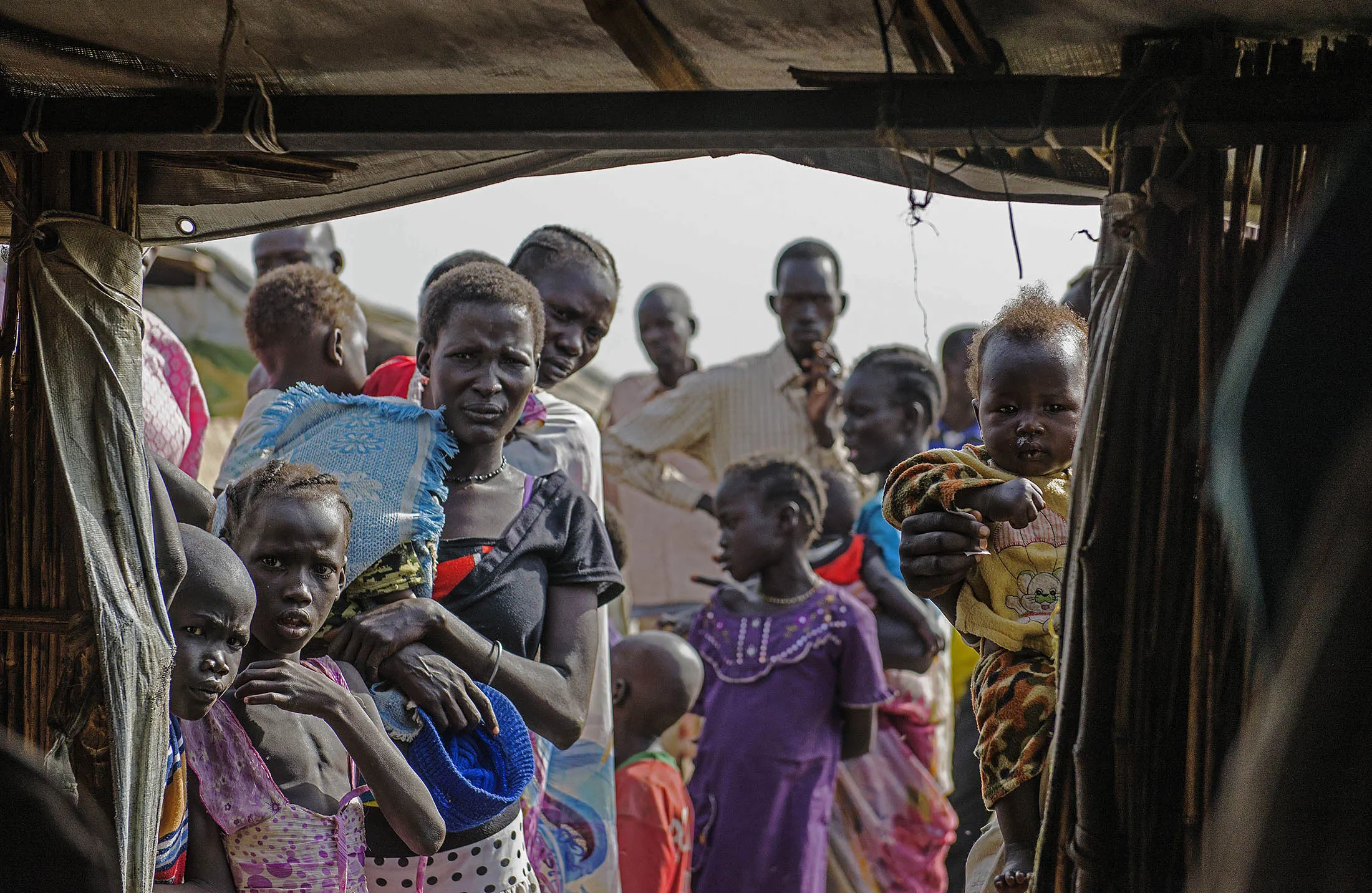 Displaced people queue to register at the UNMISS Protection of Civilian (POC) site in Bentiu, South Sudan.

