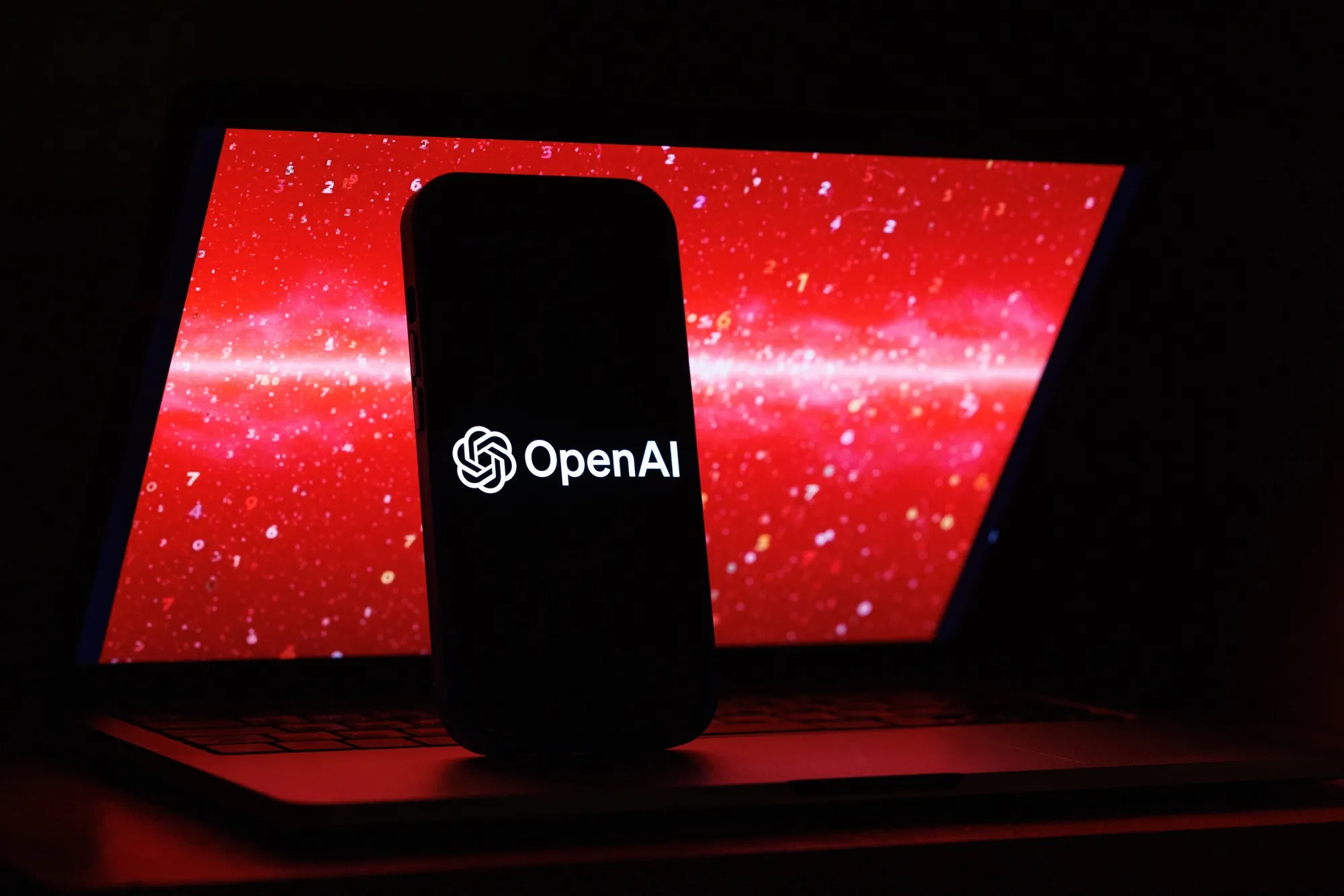 The logos of the ChatGPT and OpenAI artificial intelligence apps on a mobile phone.