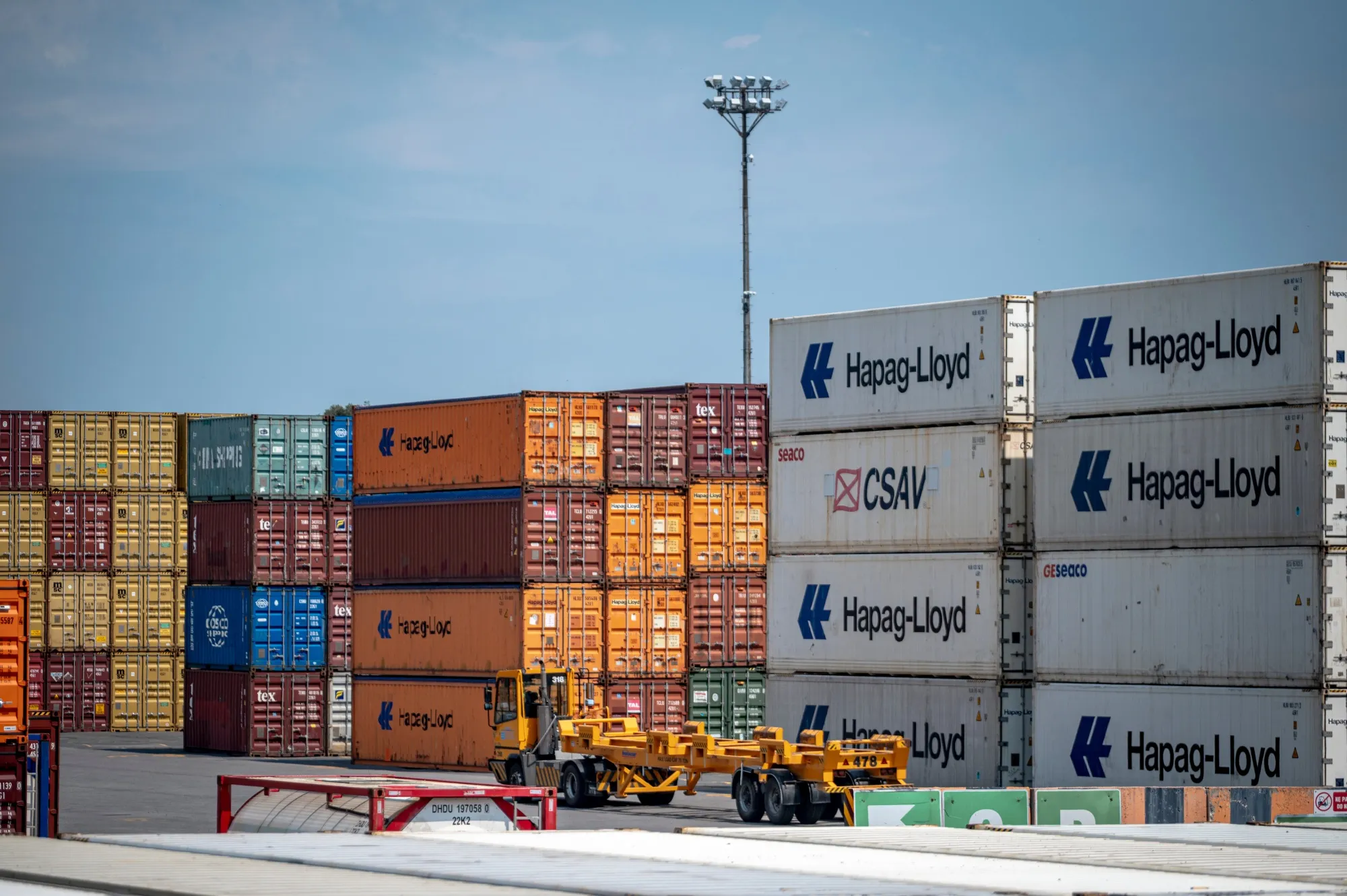 A truck drives past shipping containers at the Port of Montreal.