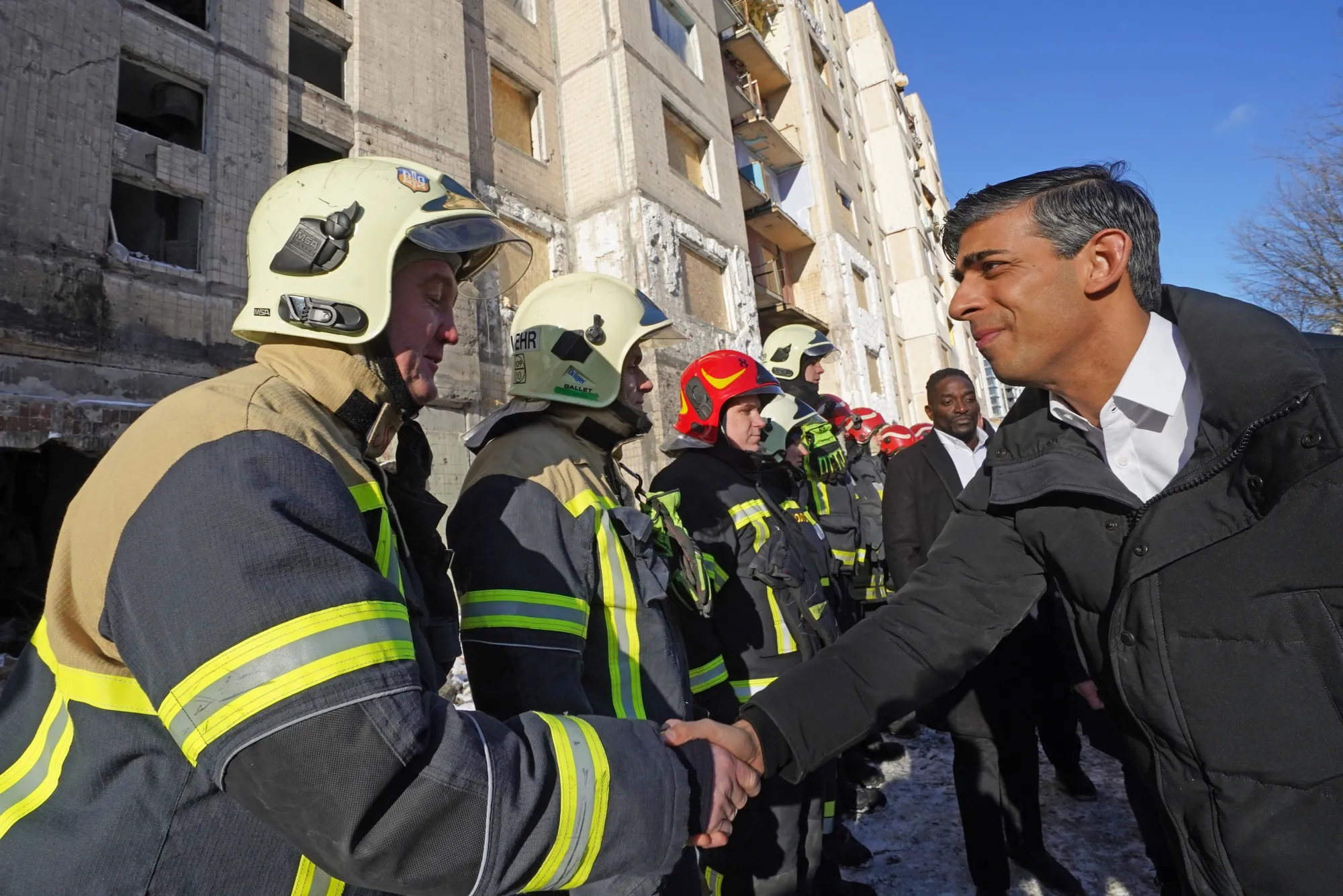 Rishi Sunak greets firefighters in Kyiv on Jan. 12.