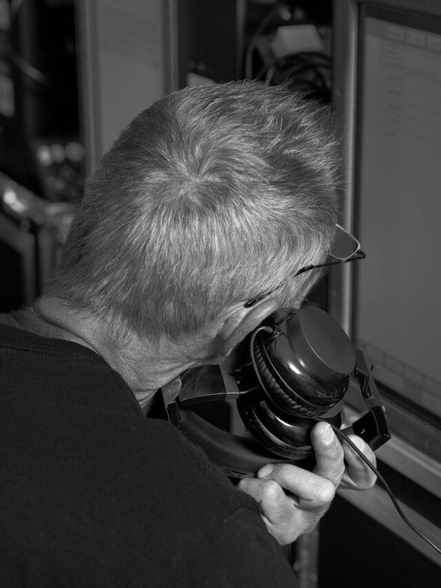 An employee demonstrates one of the accessibility capacities built into the company’s voting machines. These headphones help visually impaired voters cast their ballots.