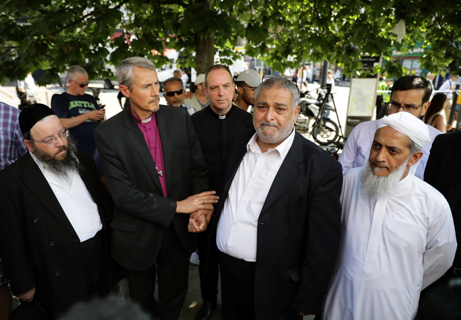 Local faith leaders stand together near Finsbury Park Mosque in a show of friendship following the attack outside the mosque in London.