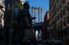 A pedestrian holds a mobile device while walking along Front Street in the Brooklyn borough of New York, U.S., on Friday, Sept. 20, 2019. Slumping tech stocks dragged down U.S. indexes as traders moved on from a busy week for central bank meetings to shift their focus back to the trade war and geopolitical tensions.
