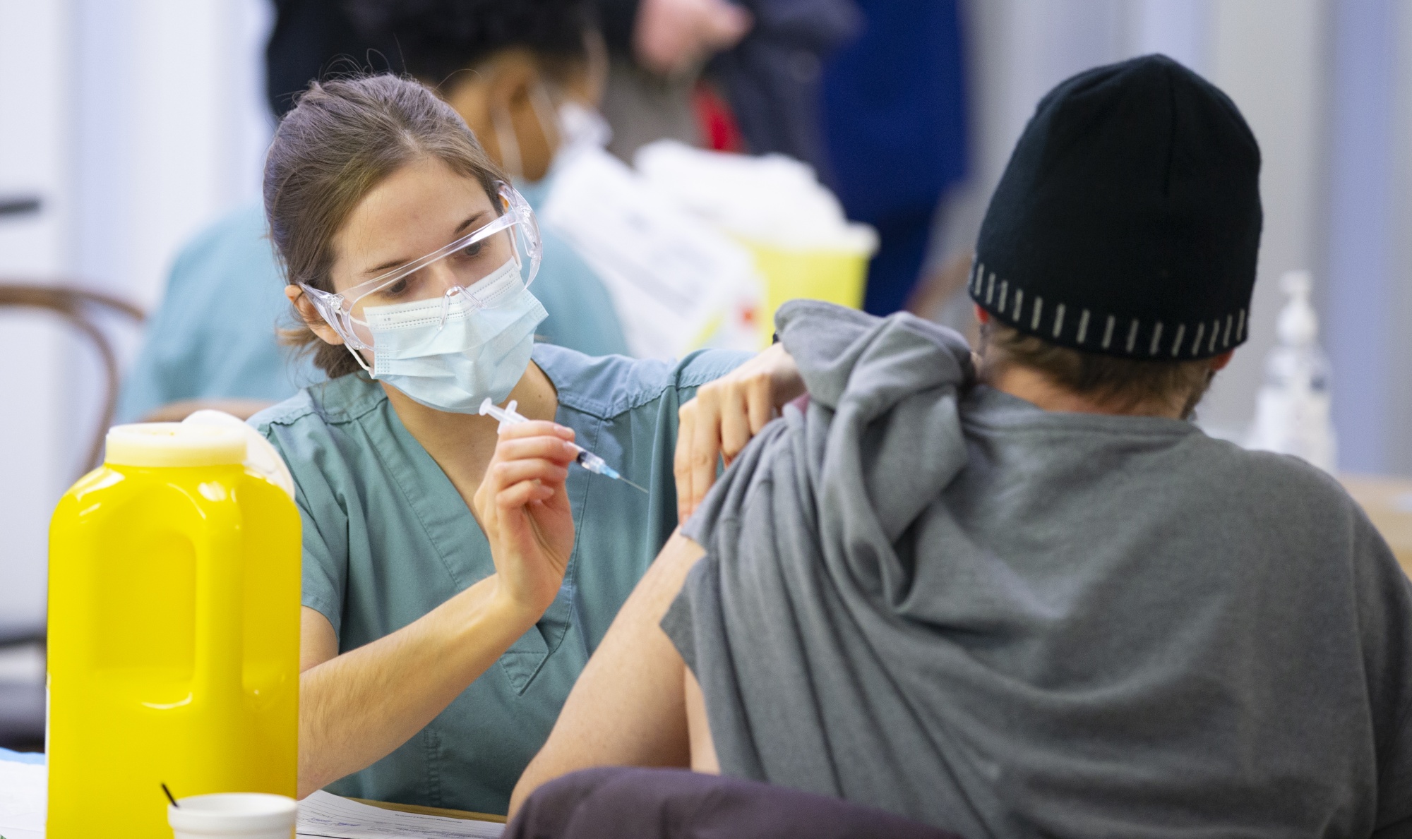 A healthcare worker administers a dose of Covid-19 vaccine at a Montreal homeless shelter on Jan. 25.