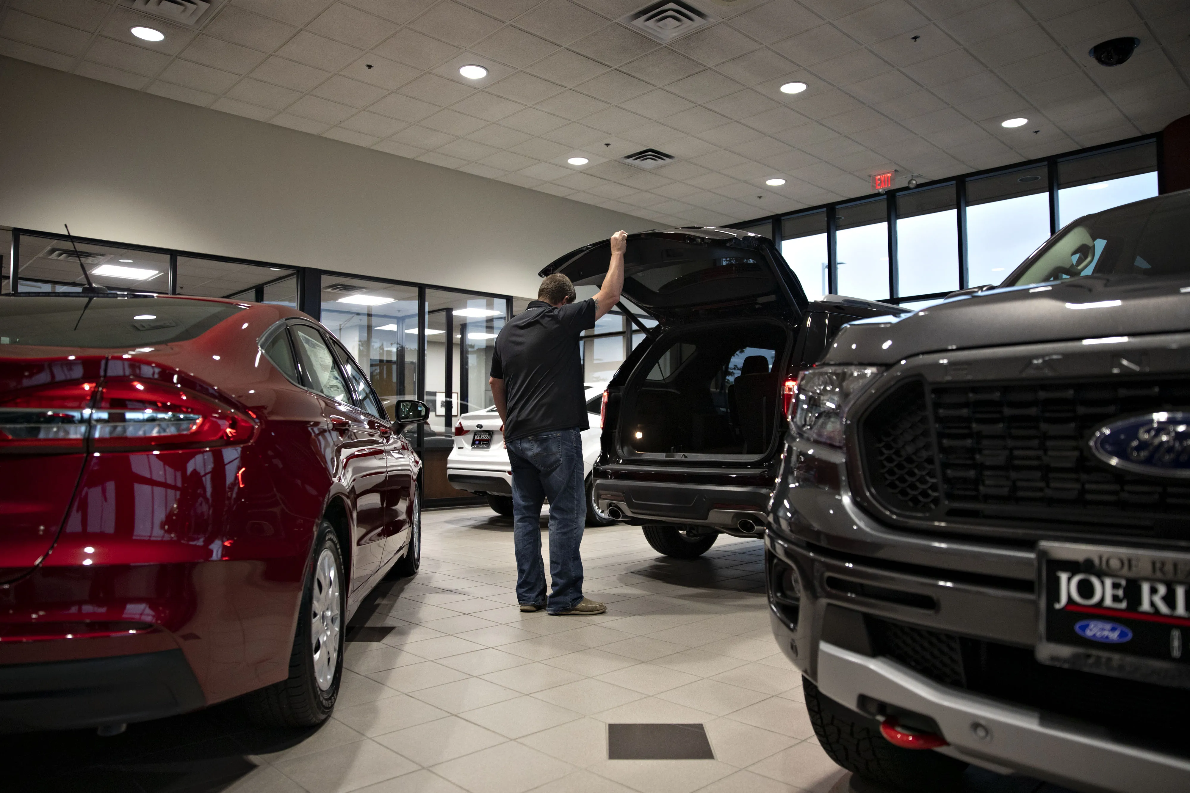 A customer looks over an SUV&nbsp;at a car dealership in Orland Park, Illinois.