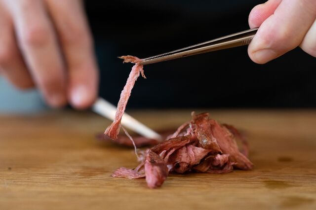 Resident Chef Amir Ilan shreds cultivated thin cut steak in preparation for a traditional Japanese beef dish in the kitchen of Aleph Farms, in Rehovot, Israel, on Sunday, November 27, 2022.