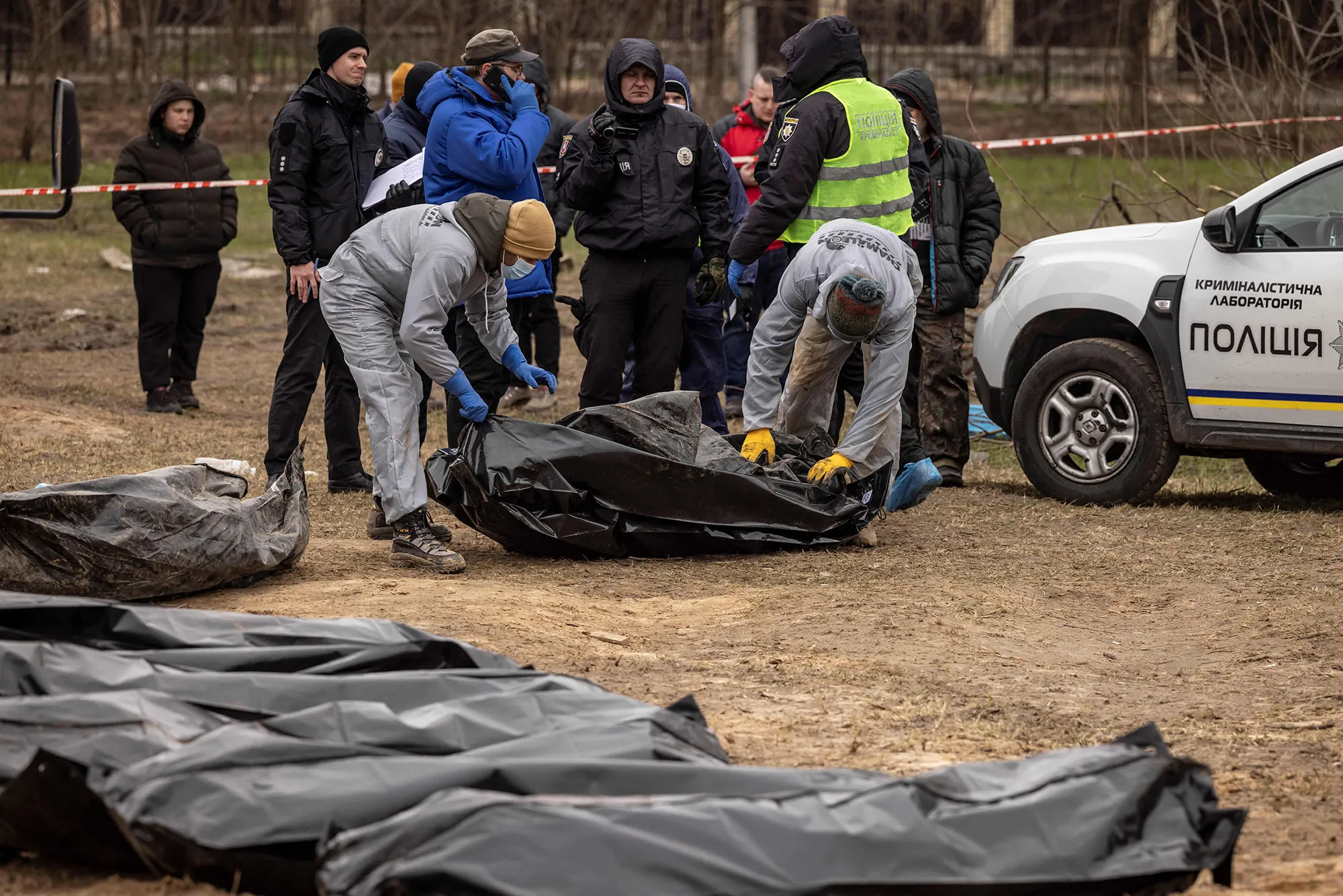 Workers wearing protective gear exhume bodies on April 13 at a site where Ukrainian civilians, killed during Russian occupation, where buried on the grounds of the Church of Saint Andrew. A visit by the International Criminal Court’s chief prosecutor to Bucha, the Kyiv suburb now synonymous with scores of atrocities against civilians, came as Vladimir Putin’s war shifts eastward.