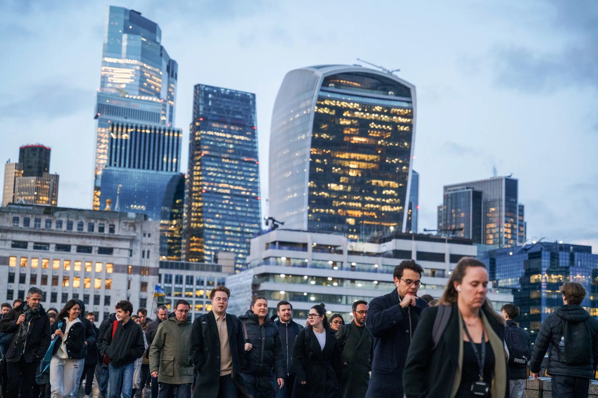 Commuters cross London Bridge in the City of London.