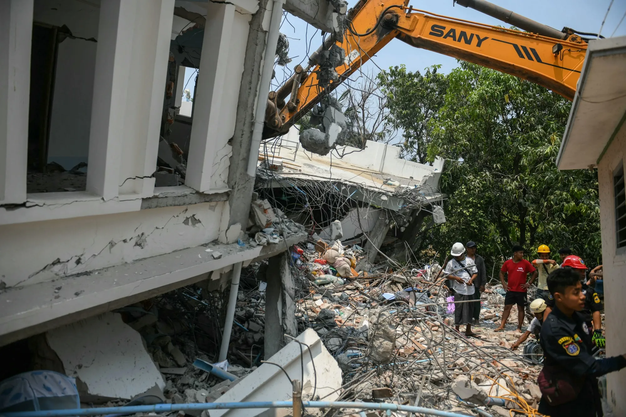 People search for survivors in a damaged building in Mandalay, Myanmar, on March 29.