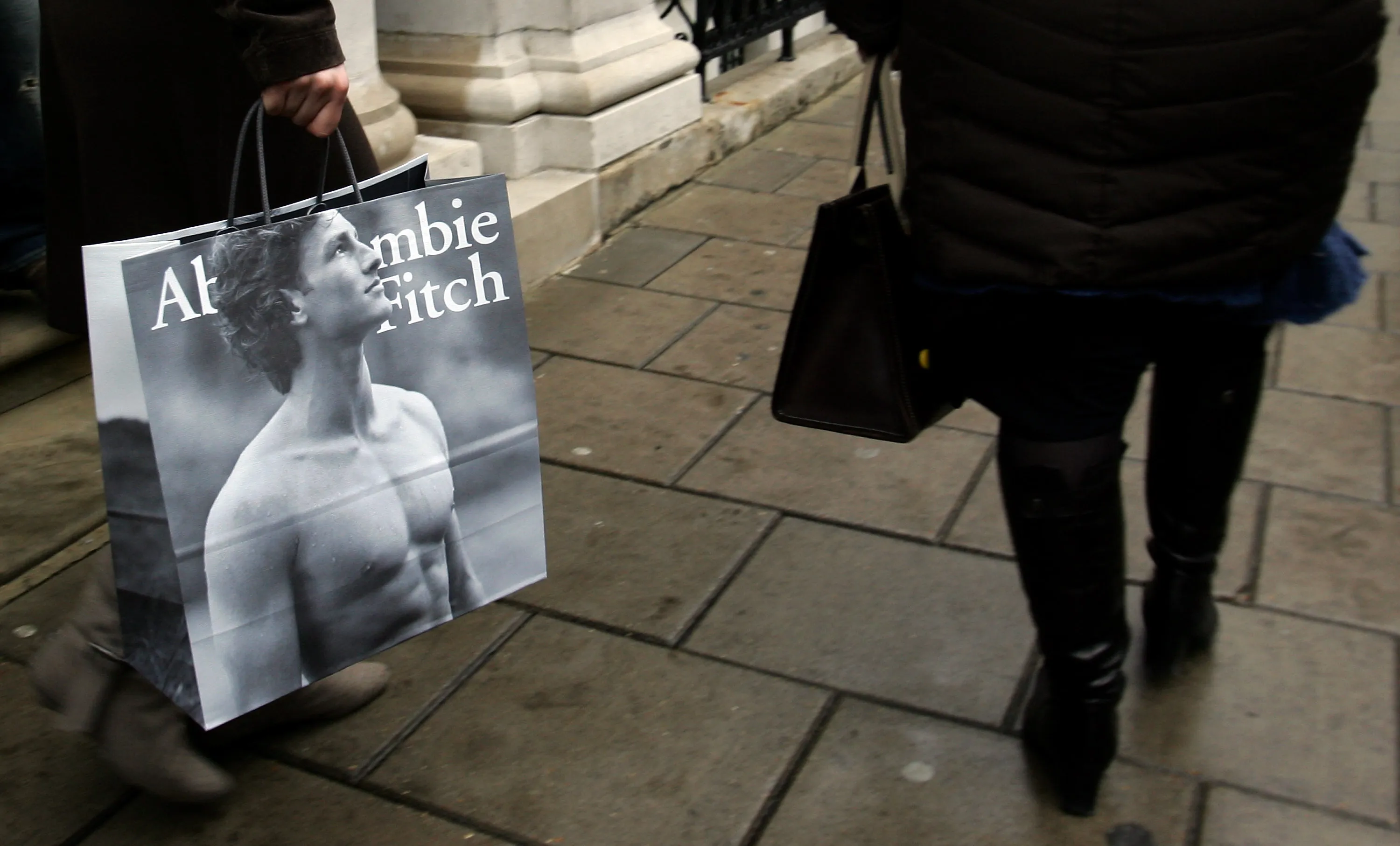 LONDON - MARCH 22:  Shoppers leave the Abercrombie & Fitch UK Flagship Store on Savile Row on March 22, 2007 in London, England. The store opened its doors today and is the labels first London branch.  (Photo by Gareth Cattermole/Getty Images)