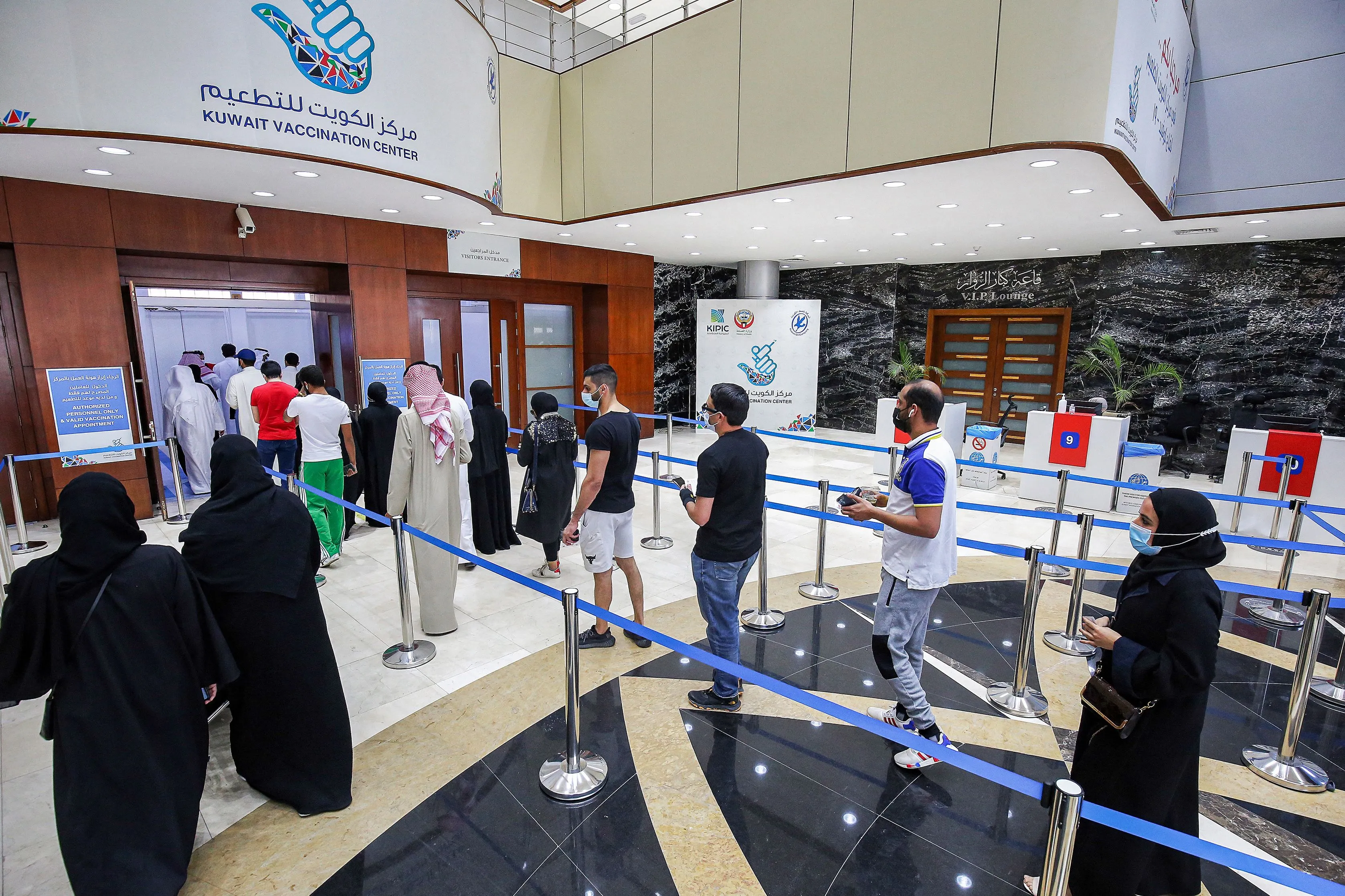 People wait in line at a vaccination center in Kuwait City on March 21.