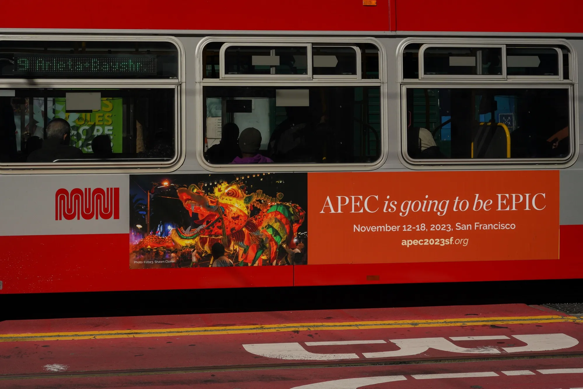 An APEC advertisement on a bus in downtown San Francisco.