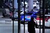 A pedestrian takes a smartphone photograph of Nissan Motor Co. vehicles on display in a showroom at the Nissan Motor Co. headquarters in Yokohama, Japan, on Thursday, Jan. 9, 2020. Nissan’s executives mostly derided attacks by Carlos Ghosn, who lashed out at the automaker he used to lead in a closely watched news conference in Lebanon following his stunning escape from trial in Japan.