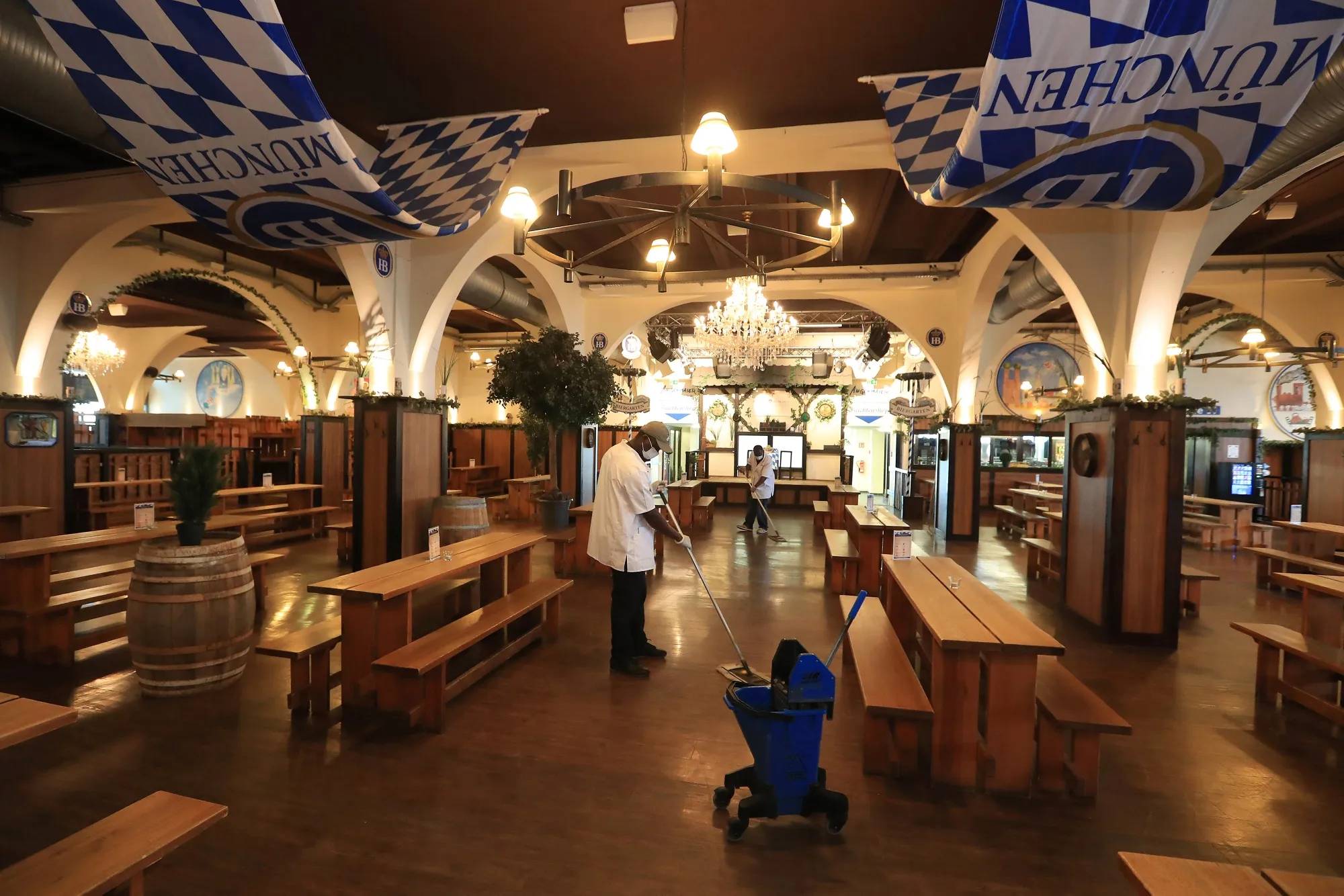 Workers mop the floor inside a Bavarian-themed beer hall ahead of reopening in Berlin on May 14.