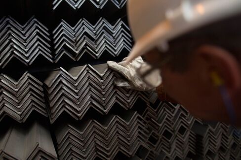 A worker inspects stores of finished steel angles at a steel mill in Cardiff, U.K., on May 18.