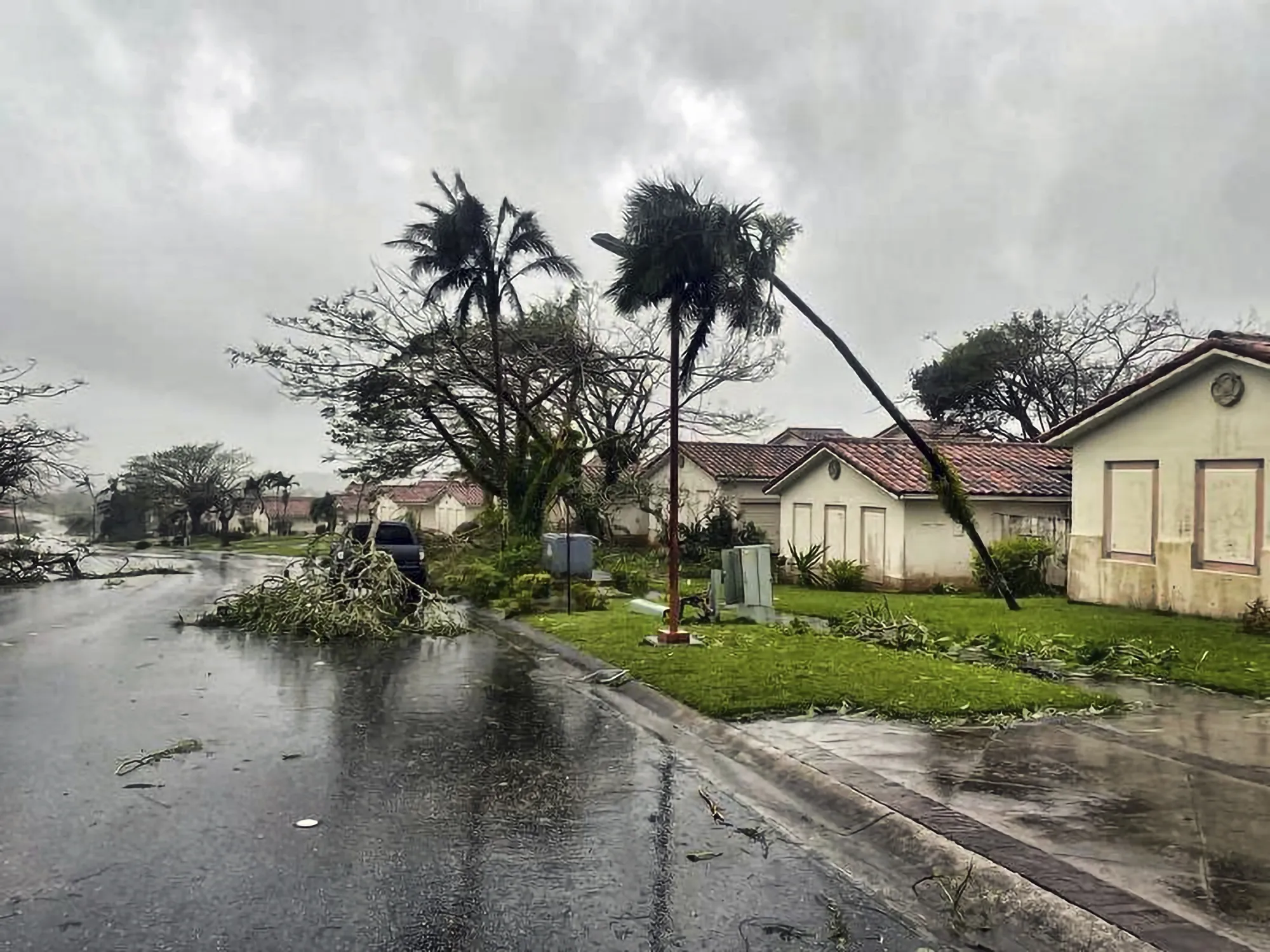 Downed tree branches litter a neighborhood in Yona, Guam on May 25.