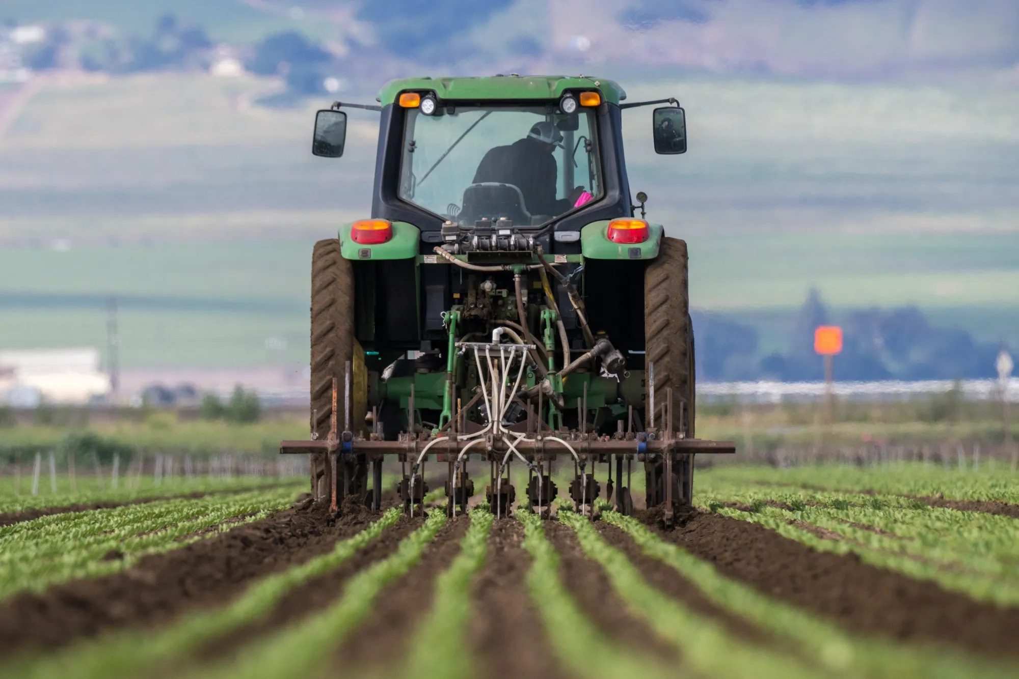 A tractor drips nitrogen fertilizer onto rows of romaine lettuce at a farm near Gonzales, California, in April.