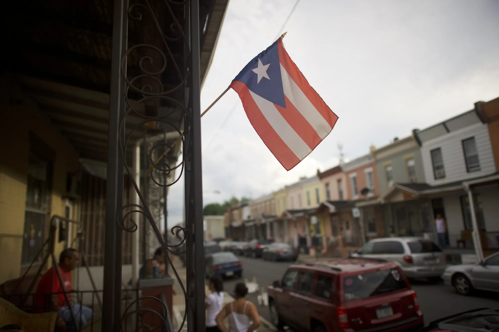 A Puerto Rican flag hangs in front of a&nbsp;rowhouse in the&nbsp;Hunting Park neighborhood of&nbsp;North Philadelphia.