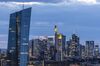 Skyscrapers including the headquarters of the European Central Bank (ECB), left, Commerzbank AG, center, and twin tower headquarters of Deutsche Bank AG, right, stand illuminated at dusk in the financial district in Frankfurt, Germany, on Tuesday, Aug. 13. 2019. Germany’s economy shrank in the second quarter, ramping up pressure on Chancellor Angela Merkel to unleash fiscal stimulus as manufacturers reel from a U.S.-China trade war.